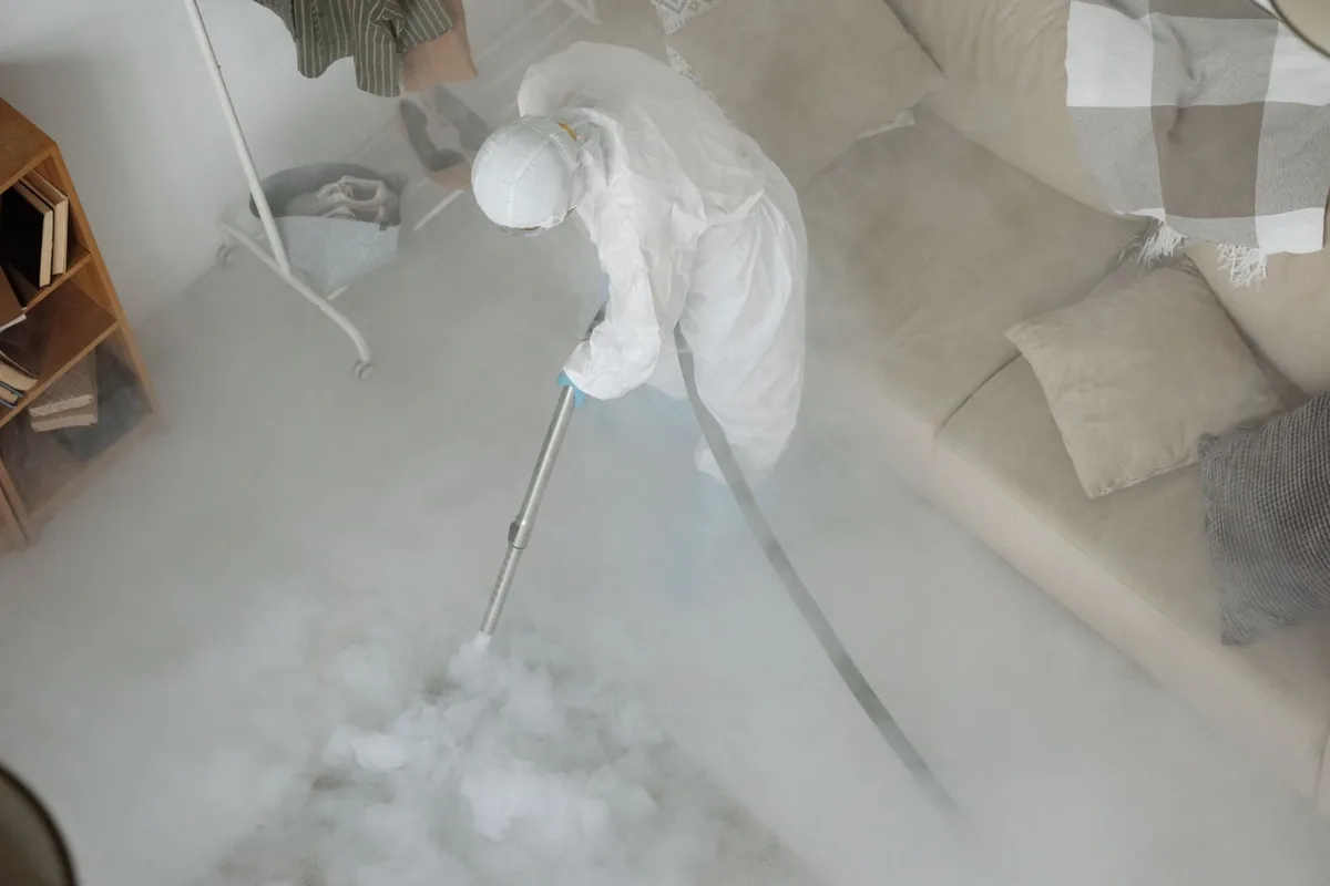 Biohazard cleanup technician in protective equipment, Brockport, NY